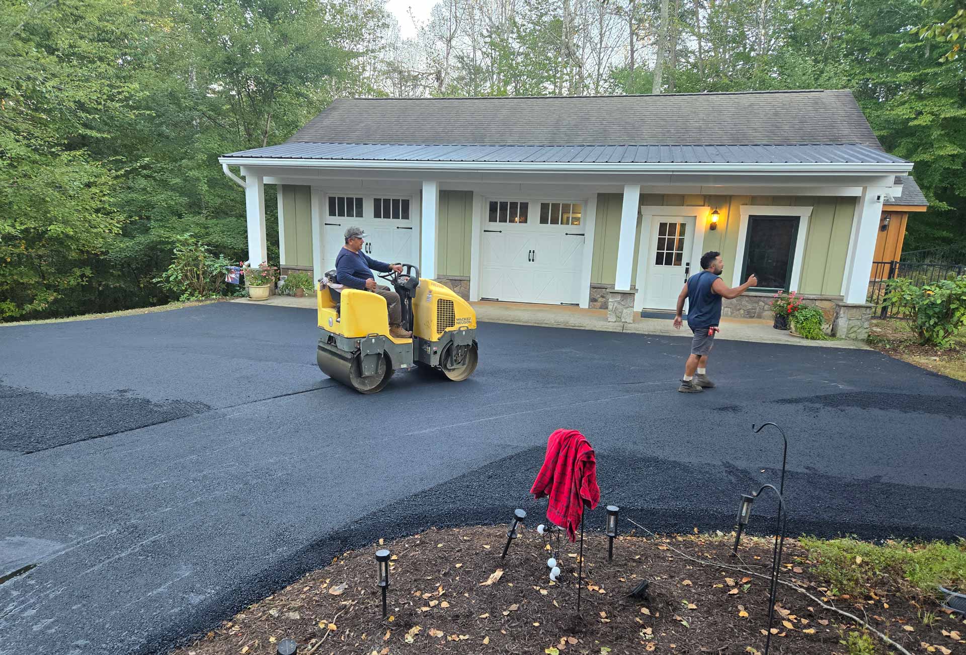 Workers from HOTMIXX LLC paving a driveway