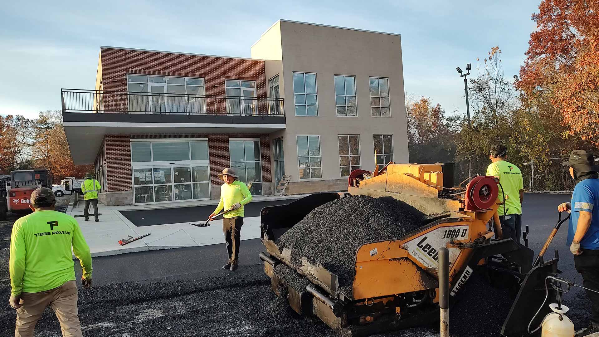 Workers from HOTMIXX LLC paving a parking lot