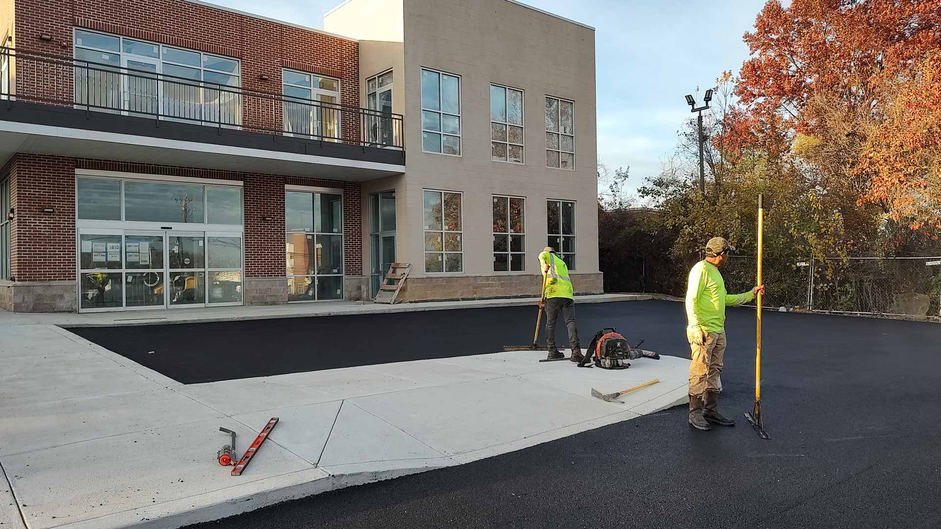 Workers from HOTMIXX LLC paving a parking lot