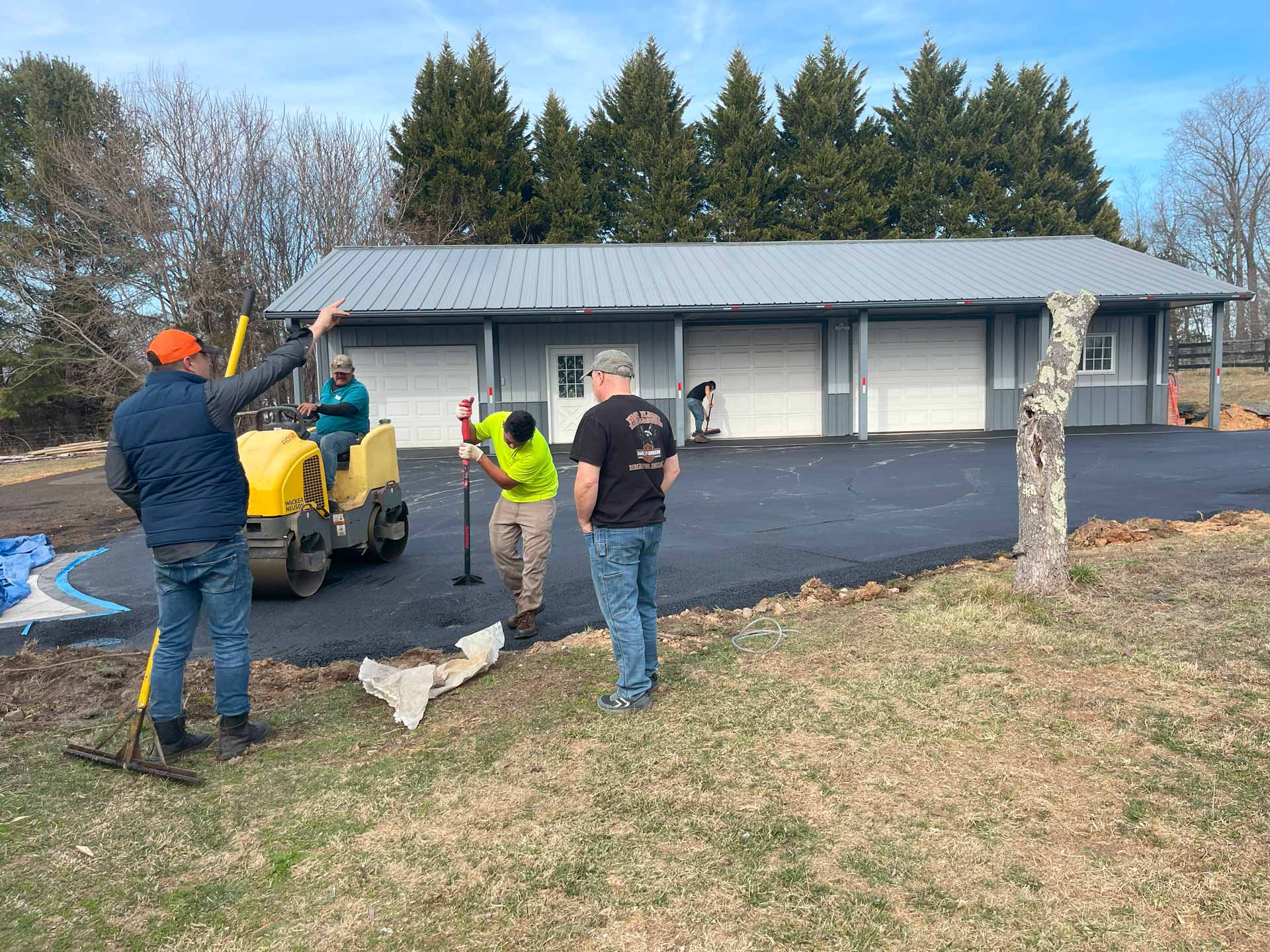 Workers from HOTMIXX LLC paving a driveway