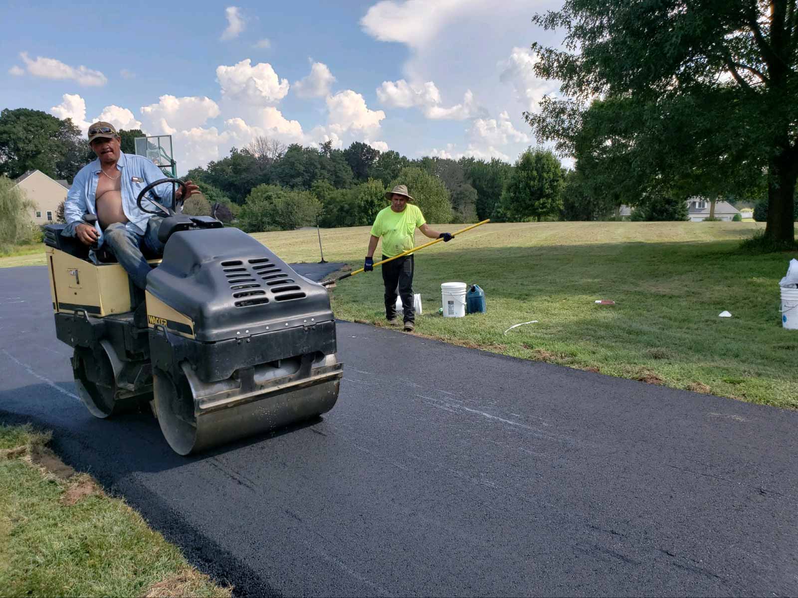 Workers from HOTMIXX LLC paving an asphalt driveway